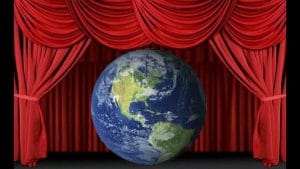 Curtain call, a globe centre stage between open red theatre curtains